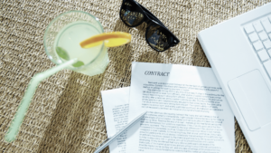 Photo of paperwork and cocktail showing work and fun balance